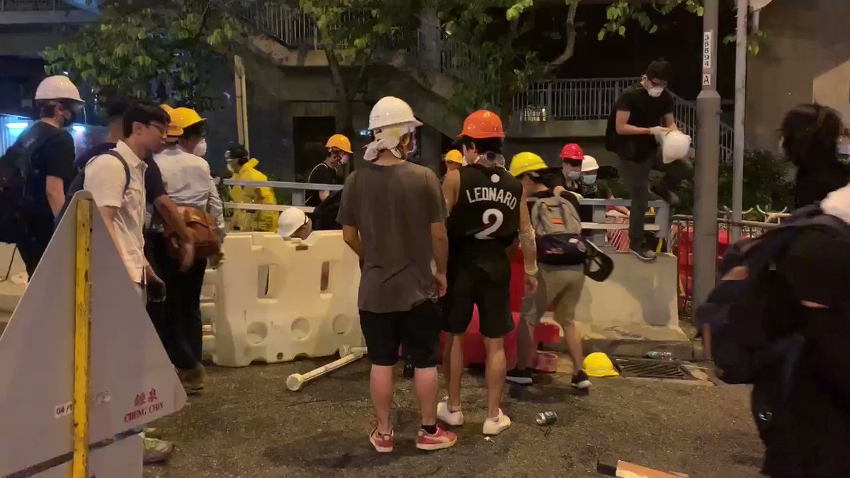 Night time barricade building on Queensway.