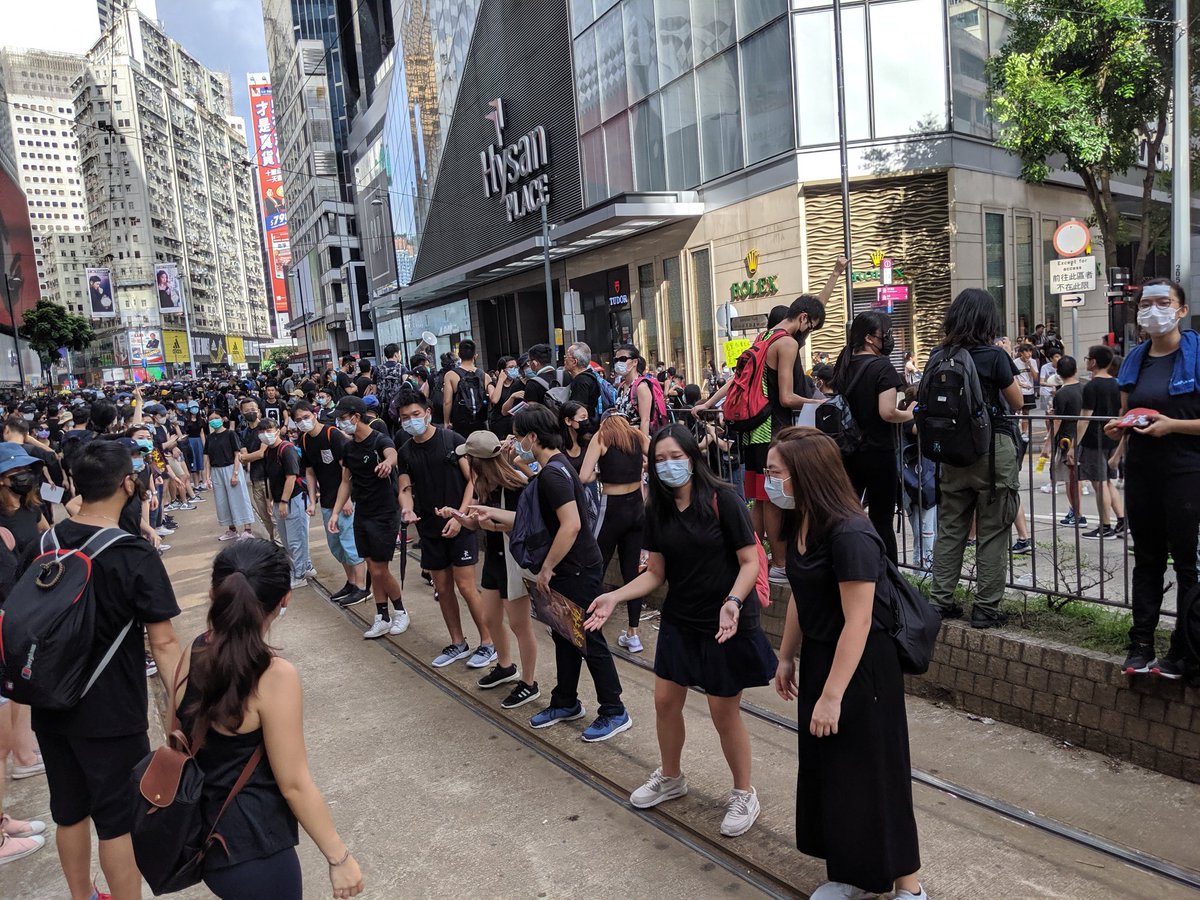 Protesters say they are stopping outside Sogo shopping mall in Causeway Bay for now. They have marched here - without police permission - from Central's Chater Garden.  A supply line has been set up. HongKongProtests #antiELAB