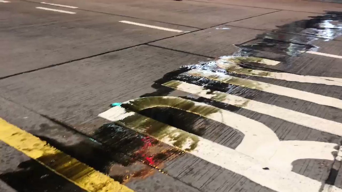A line of liquid has also been splashed on Nathan Road.between the police's cordon line and protesters. Some journalists say it's petrol