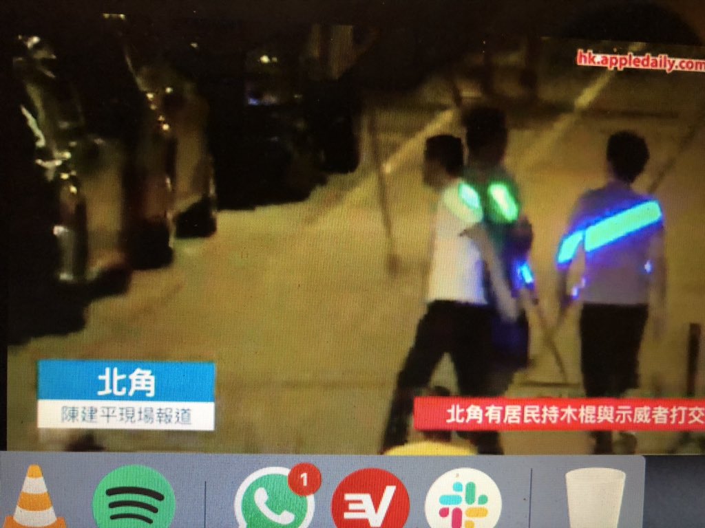 Men with sticks chasing protesters in North Point