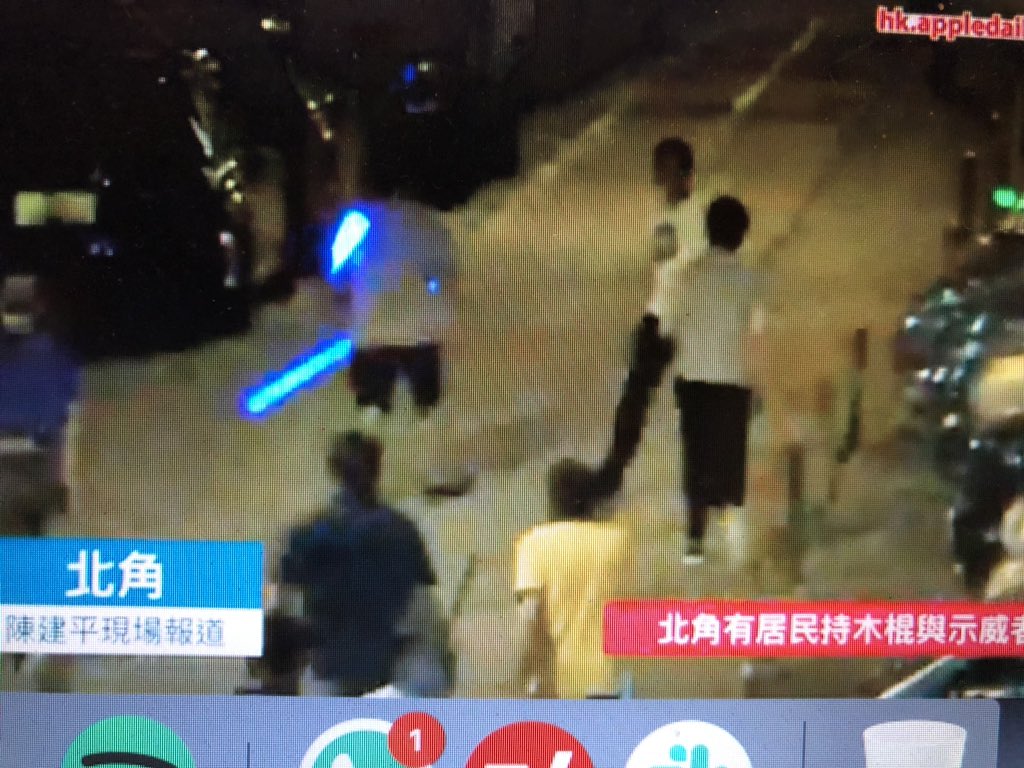 Men with sticks chasing protesters in North Point