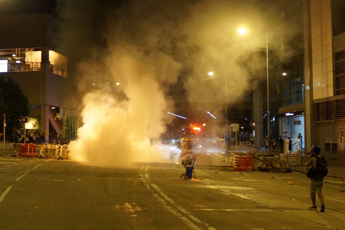 Scenes of tear gas and flaming barricades in Tuen Mun on Monday night, as riot police attempt an advance towards protesters.  Photo: Kris ChengHKFP.  #antiELAB