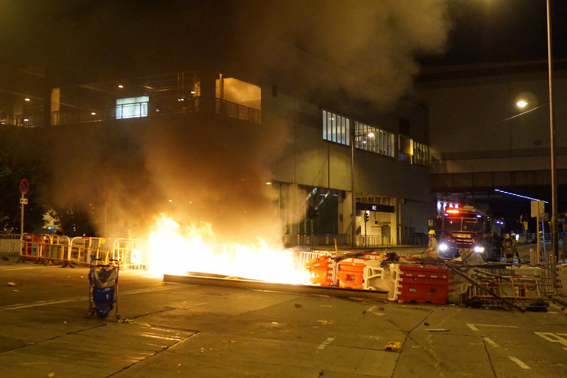 Scenes of tear gas and flaming barricades in Tuen Mun on Monday night, as riot police attempt an advance towards protesters.  Photo: Kris ChengHKFP.  #antiELAB