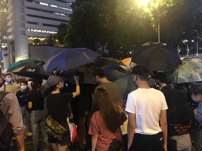 Dozens of protesters are surrounding a man on Connaught Road Central who, according to witnesses, has photographed demonstrators' faces. The demonstrators demand that he delete his photos  