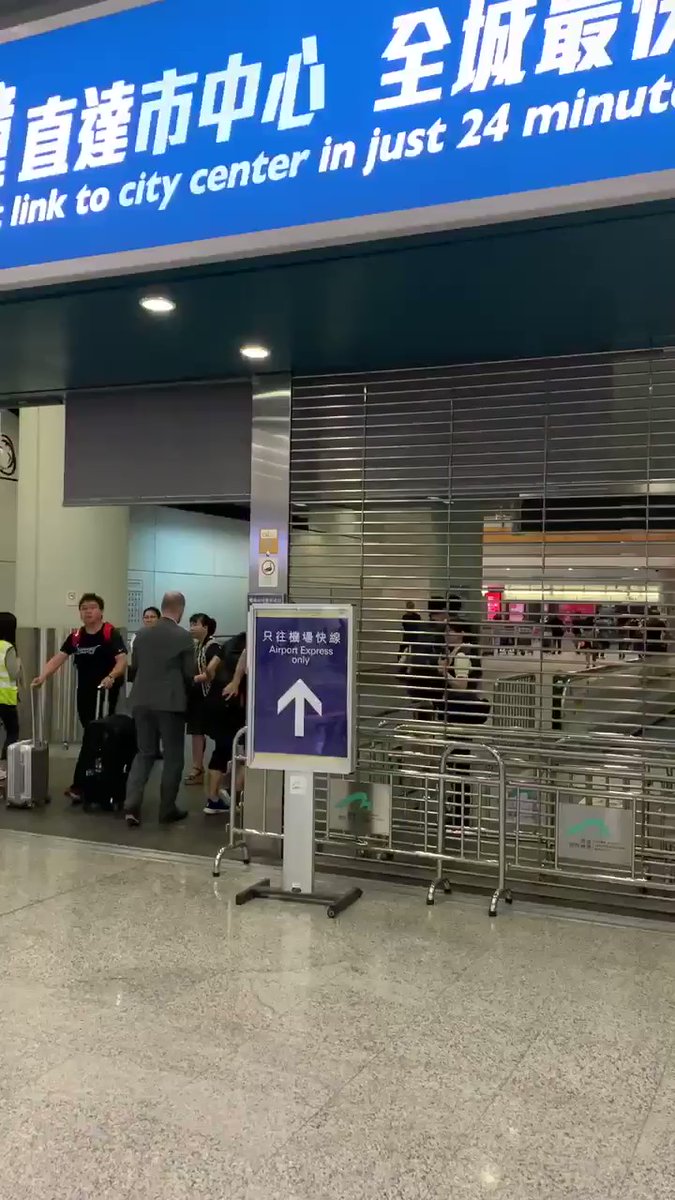 They are shutting the airport express at the Hong Kong airport. People are rushing to get in before it's too late