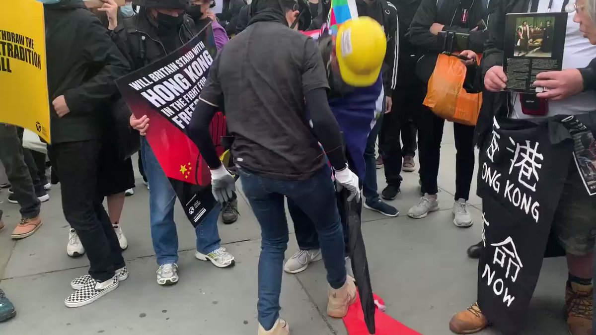Trafalgar Square, London. Hong Kong protestors destroying China's flag