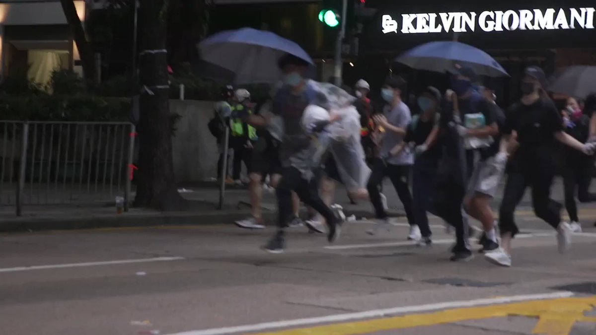 Wan Chai earlier: two protests running away from police holding hands