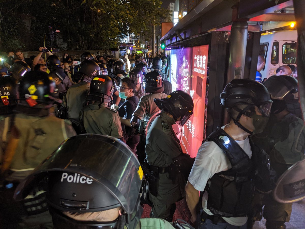 Riot police came out from TST station to search a man and woman. They removed their masks temporarily during the search