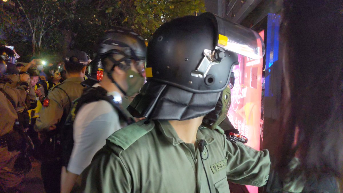 Riot police came out from TST station to search a man and woman. They removed their masks temporarily during the search