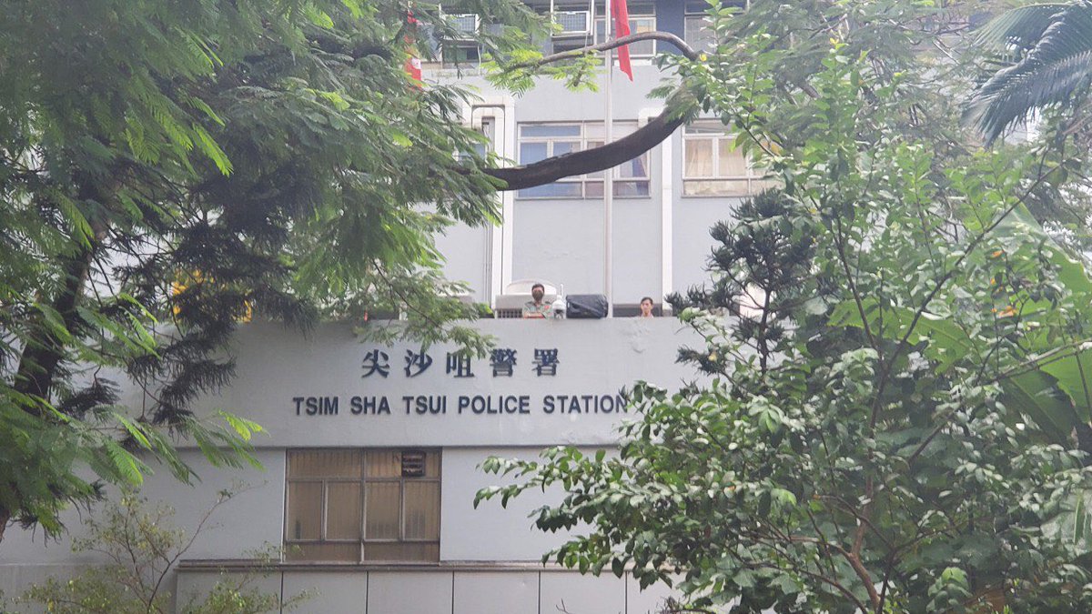 Police have set up security cameras above their Tsim Sha Tsui Station as masked protesters hurl insults at 3:30pm.  Photo: HKFP. 