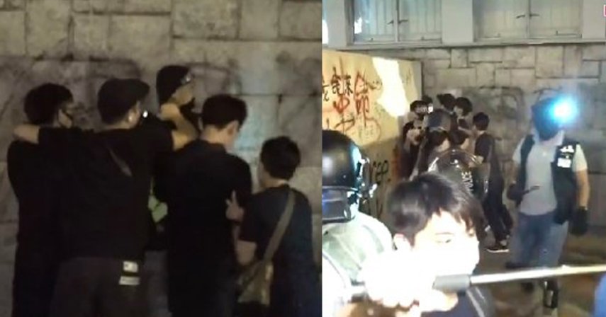 At least two arrests were suddenly made by plainclothes police at around 9:30pm outside Mong Kok Police Station. Photo: Apple Daily screenshot.