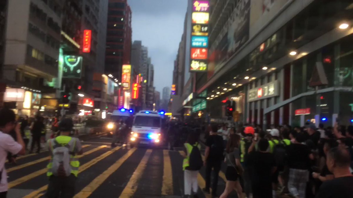 Dozens of riot police remain stationed at the junction between Argyle Street and Nathan Road at 6pm. Locals heckle them with shouts of triads and rapists.  Photo: HKFP.