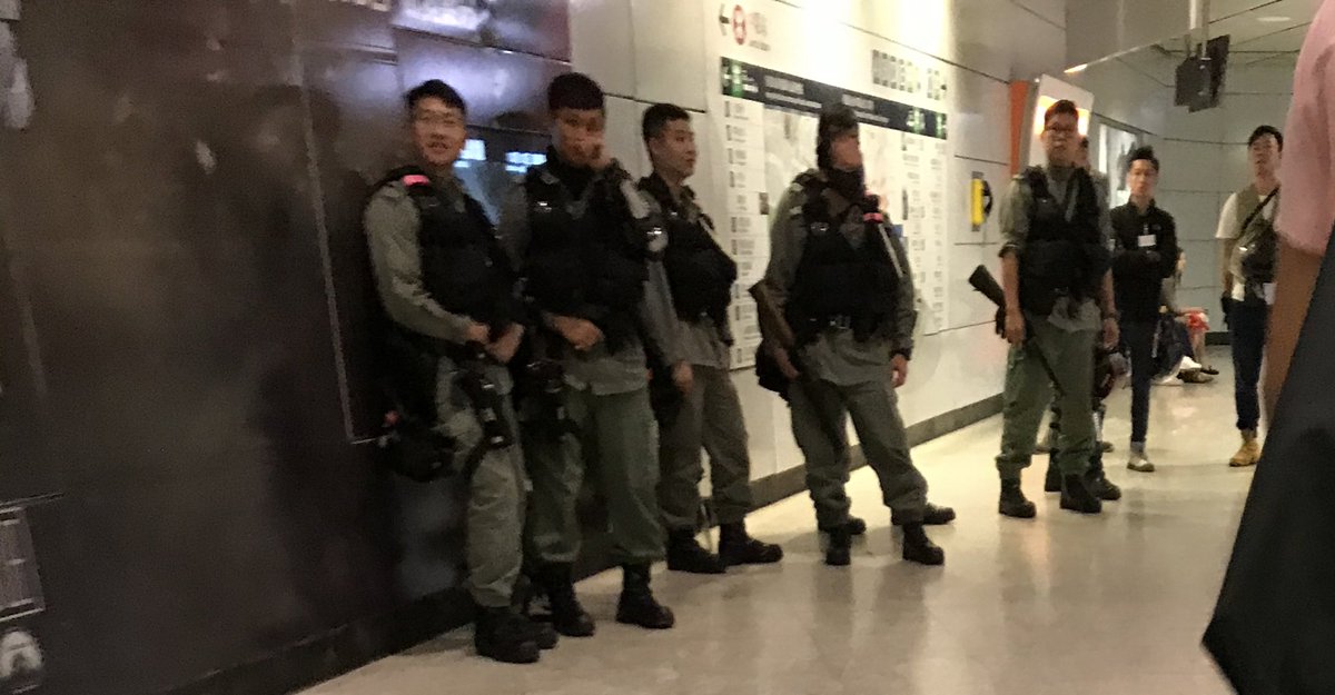 Riot police in the tunnel between Central & Hong Kong stations during rush hour