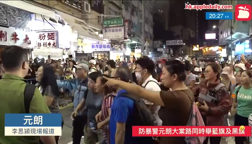 An @appledaily_hk reporter just attacked by a group of pro-Beijing supporters near the Tai Tong Road light rail stop, as she attempted to cover a scuffle between the yellow and blue camps. They can be seen throwing bottles, bicycles, etc, at each other