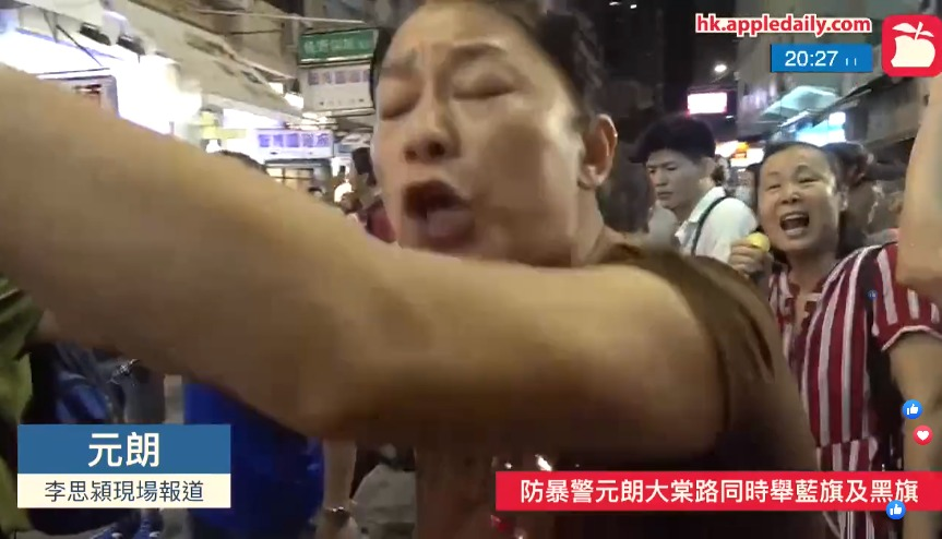 An @appledaily_hk reporter just attacked by a group of pro-Beijing supporters near the Tai Tong Road light rail stop, as she attempted to cover a scuffle between the yellow and blue camps. They can be seen throwing bottles, bicycles, etc, at each other