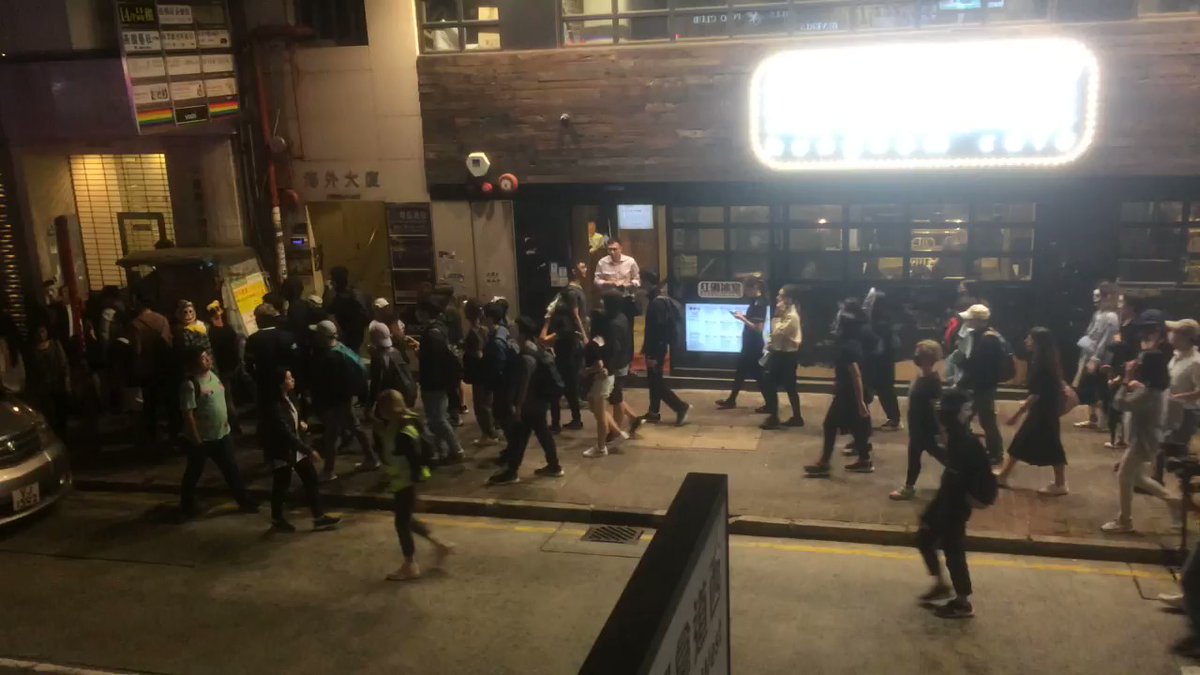 Masked protesters march through Wanchai at 8:15pm.