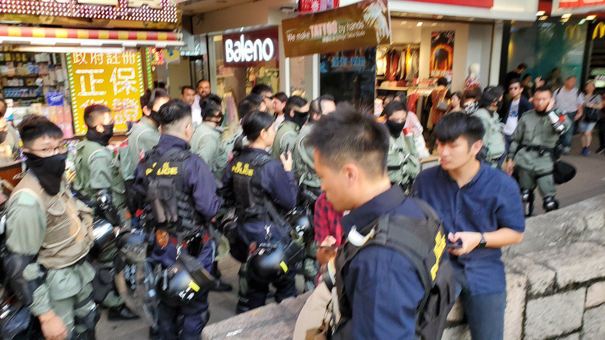 Riot police and tactical unit officers have emerged from Tsim Sha Tsui police station and walked north on Nathan Road, despite police having authorised a protest on Park Lane.  #hongkong