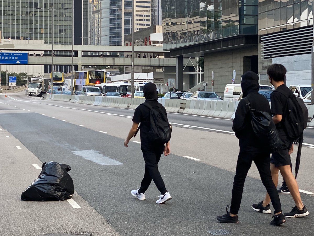 Connaught Road Central outside City Hall being blocked off in both directions, as police vans become visible