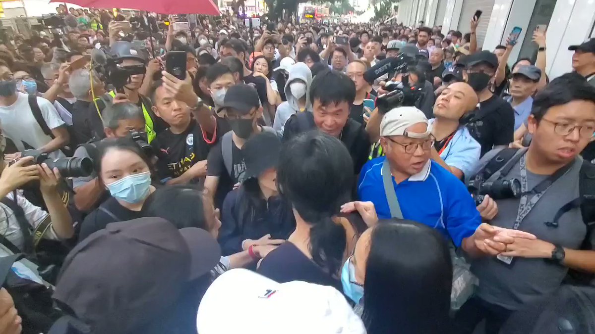 Tensions escalate again in Tsim Sha Tsui after a young woman is accused of taking photos of the scene suspiciously. Marshals attempt to calm the situation. 