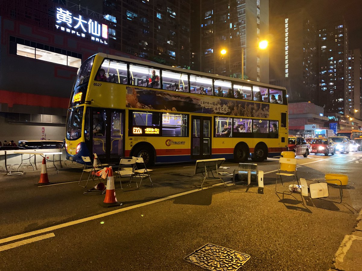 Protestors block a road in Wong Tai Sin