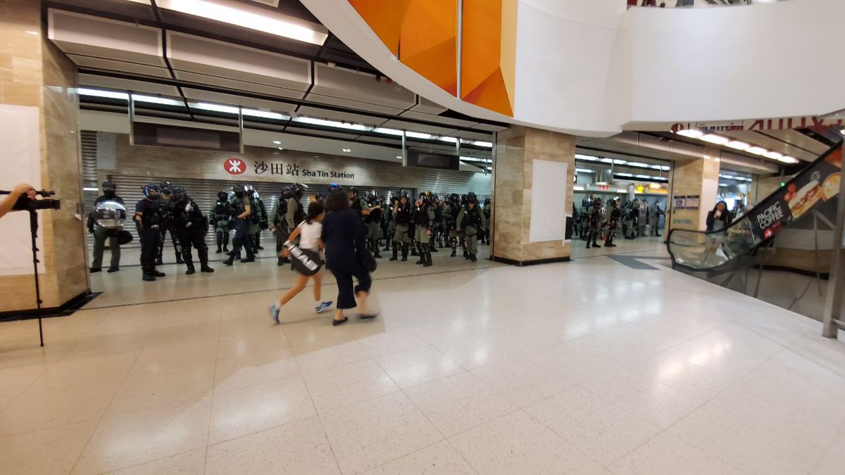 Multi-district flash protests are beginning to take place on Sunday afternoon. Following some vandalism, Shatin MTR Station was closed shortly before 3pm, as riot police positioned themselves inside.  Photo: HKFP. 