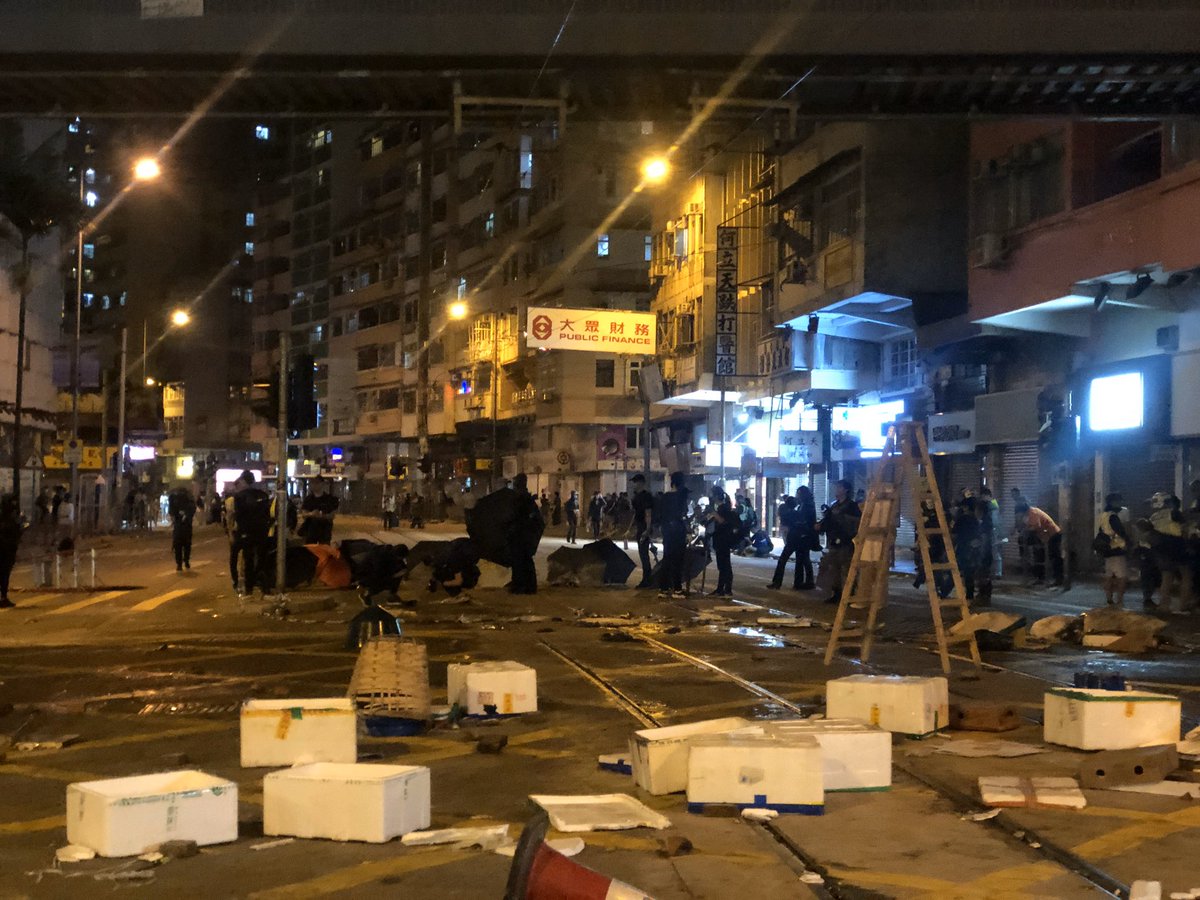 Protestors building barricades on Monday evening at Sai Wan Ho where a 21 year old man was shot by a live bullet earlier today 