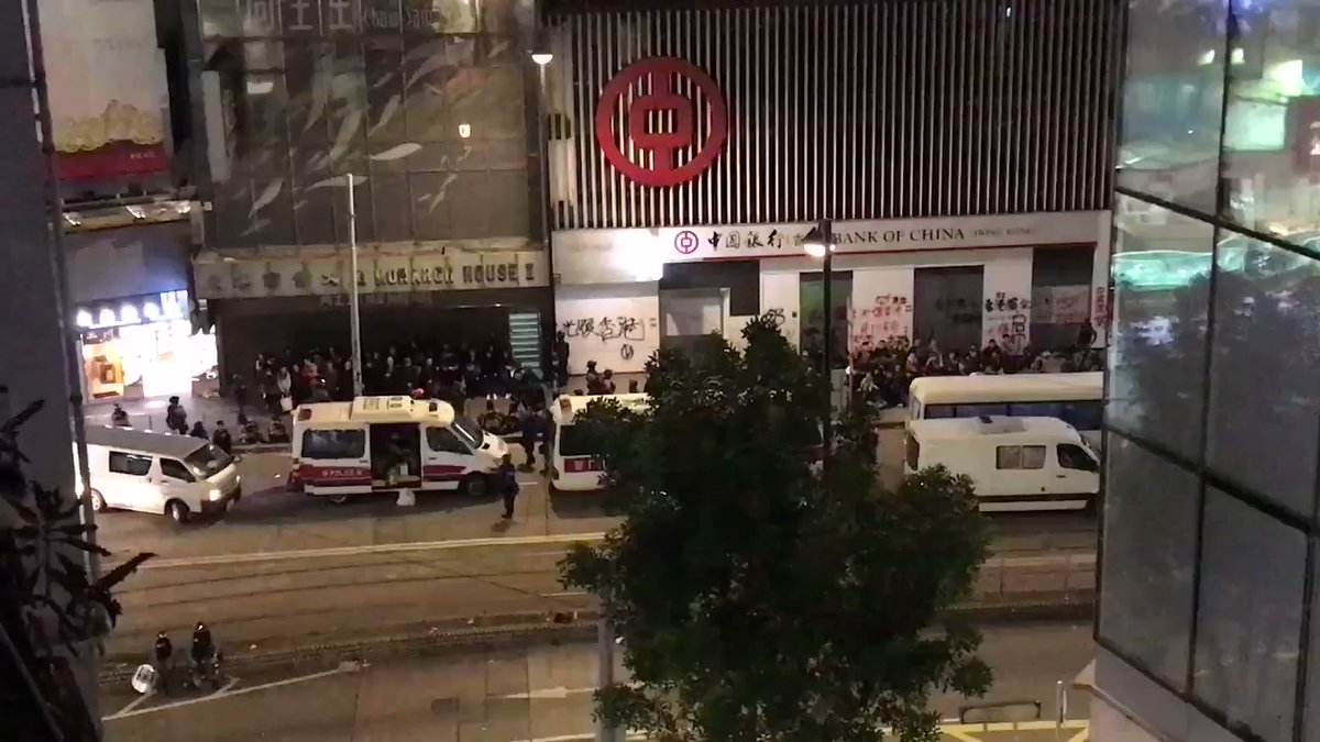 Police say they arrested over 400 people in Causeway Bay today, including around 70 here on Hennessy Road, lined up against the wall in rows awaiting processing. Few look like hardened frontliners. This rooftop is the closest media can get to record the scene
